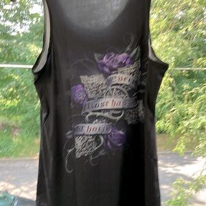 Woman’s sleeveless top. Says every rose has a thorn.
